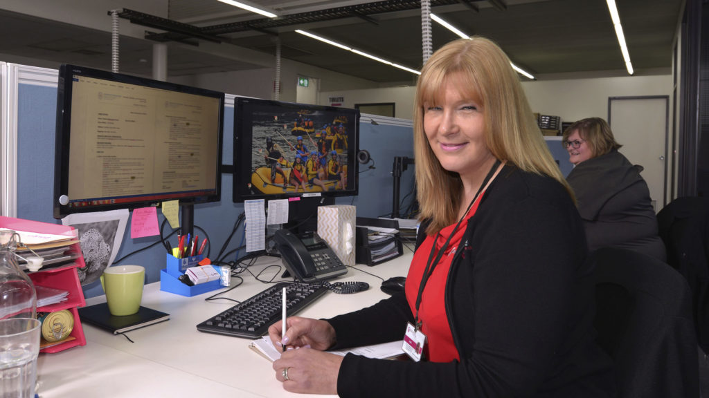 Carer in front of computer